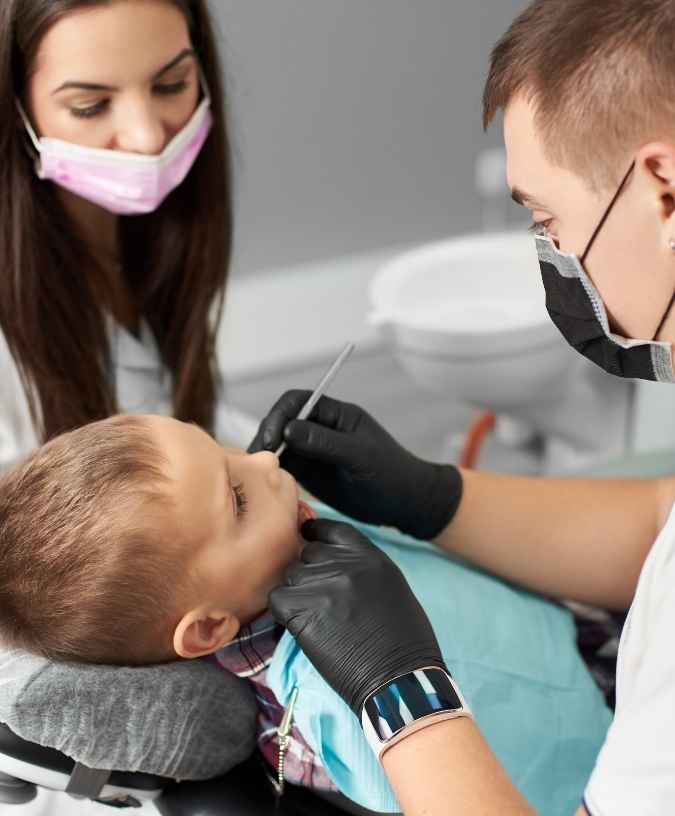 Child receiving emergency dental care from a dentist